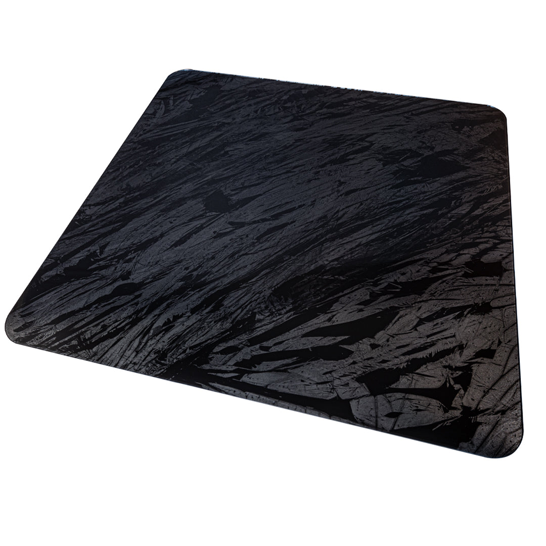 #color_forest flows alt="A square, dark grey chair mat with a textured, abstract pattern resembling flowing lines or brush strokes, shown against a white background. The mat has rounded corners and a smooth surface."