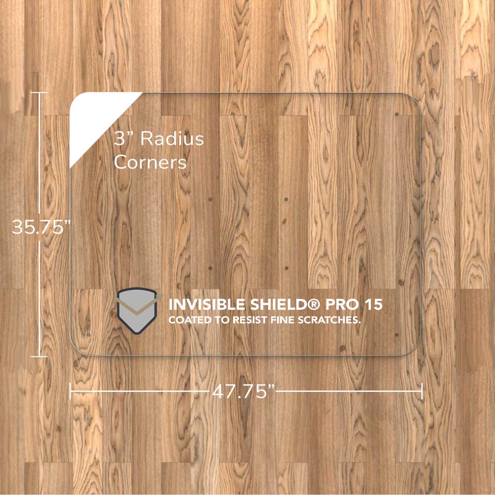 #glass clarity_luminoso (low-iron ultra clear) alt="A square "luminoso" glass chair mat with dimensions of 35.75 inches by 47.75 inches, featuring 3-inch radius corners. The mat is labeled with "INVISIBLE SHIELD® PRO 15 COATED TO RESIST FINE SCRATCHES." placed on a wooden floor."