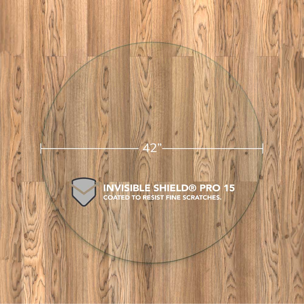 #glass clarity_chiaro (standard clear) alt="A round "chiaro" glass chair mat with a diameter of 42 inches, placed on a wooden floor. The mat is labeled with "INVISIBLE SHIELD® PRO 15 COATED TO RESIST FINE SCRATCHES."