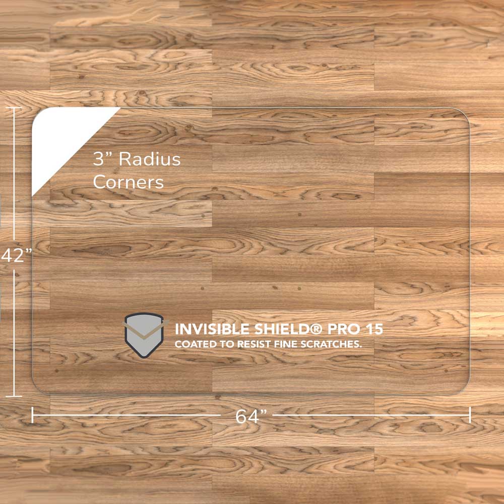 #glass clarity_luminoso (low-iron ultra clear) alt="A rectangular luminoso glass chair mat with dimensions of 64 inches by 42 inches, featuring 3-inch radius corners. The mat is labeled with "INVISIBLE SHIELD® PRO 15 COATED TO RESIST FINE SCRATCHES." and is placed on a wooden floor."
