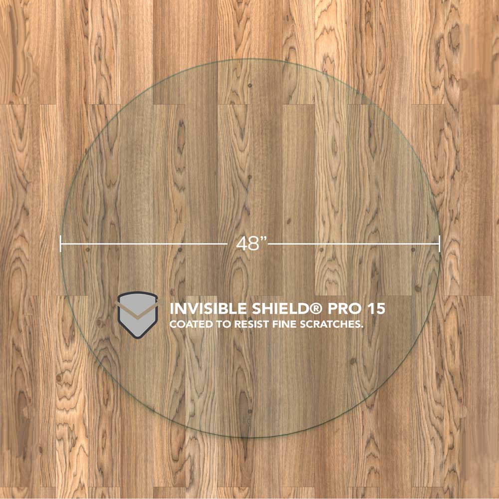 #glass clarity_chiaro (standard clear) alt="A round "chiaro" glass chair mat with a diameter of 48 inches, placed on a wooden floor. The mat is labeled with "INVISIBLE SHIELD® PRO 15 COATED TO RESIST FINE SCRATCHES."