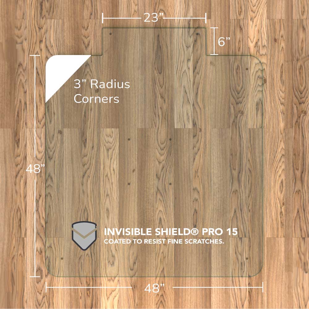 #glass clarity_chiaro (standard clear) alt="A rectangular "chiaro" glass chair mat with dimensions 48 inches by 48 inches, featuring a 23-inch wide top section and 6-inch extension, and 3-inch radius corners. The mat is labeled with "INVISIBLE SHIELD® PRO 15 COATED TO RESIST FINE SCRATCHES." and is placed on a wooden floor."