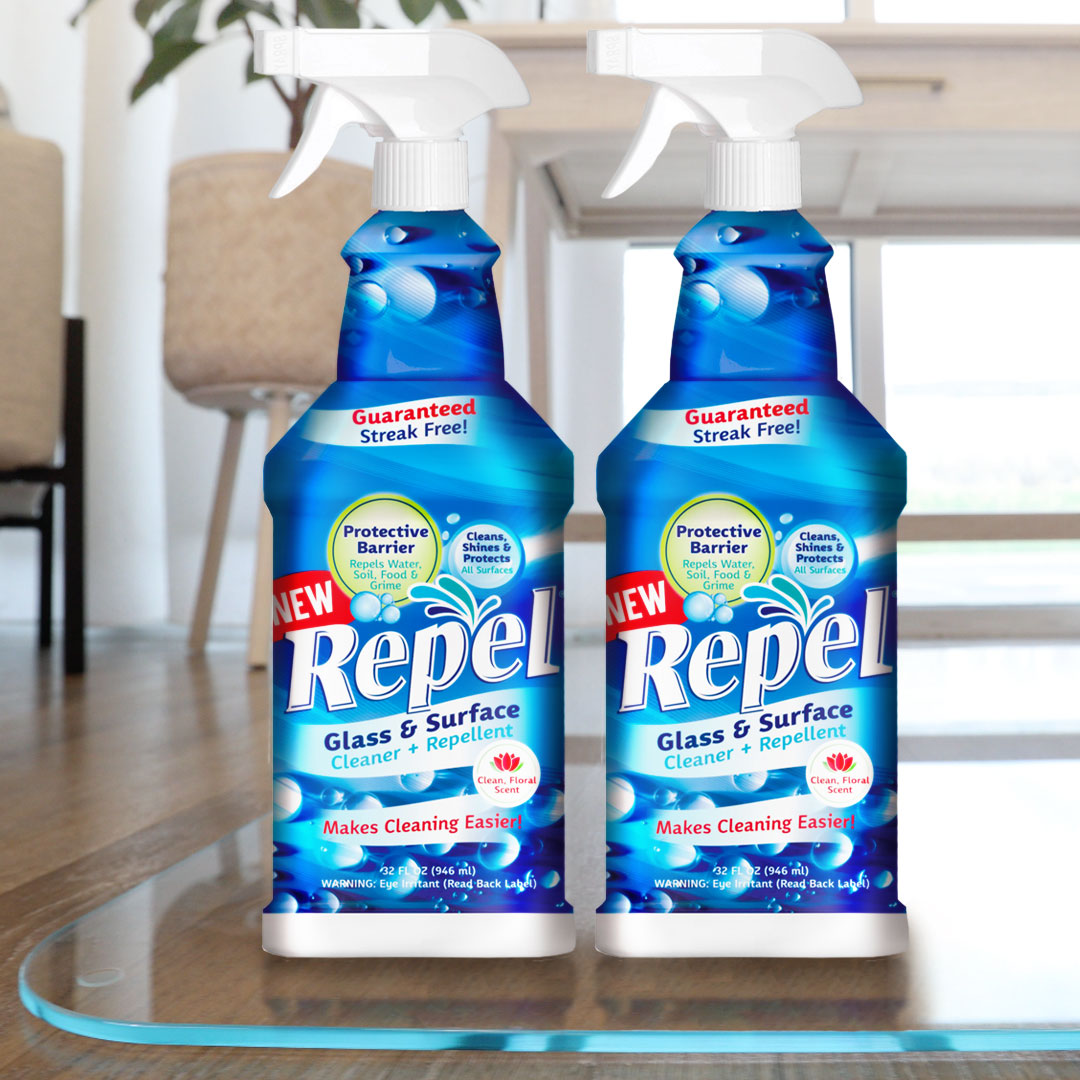 Two bottles of Repel Glass and Surface Cleaner on top of a glass chair mat