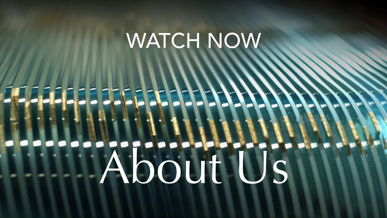"Cart full of Glass Chair Mats used as a video thumbnail with text overlay saying 'WATCH NOW' and 'About Us'."