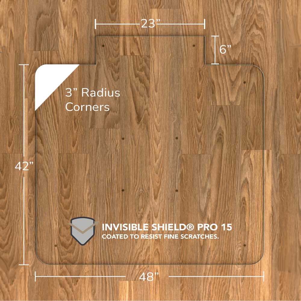 #glass clarity_luminoso (low-iron ultra clear) alt="A rectangular "luminoso" glass chair mat with dimensions 48 inches by 42 inches, featuring a 23-inch wide top section and 6-inch extension, and 3-inch radius corners. The mat is labeled with "INVISIBLE SHIELD® PRO 15 COATED TO RESIST FINE SCRATCHES." and is placed on a wooden floor."