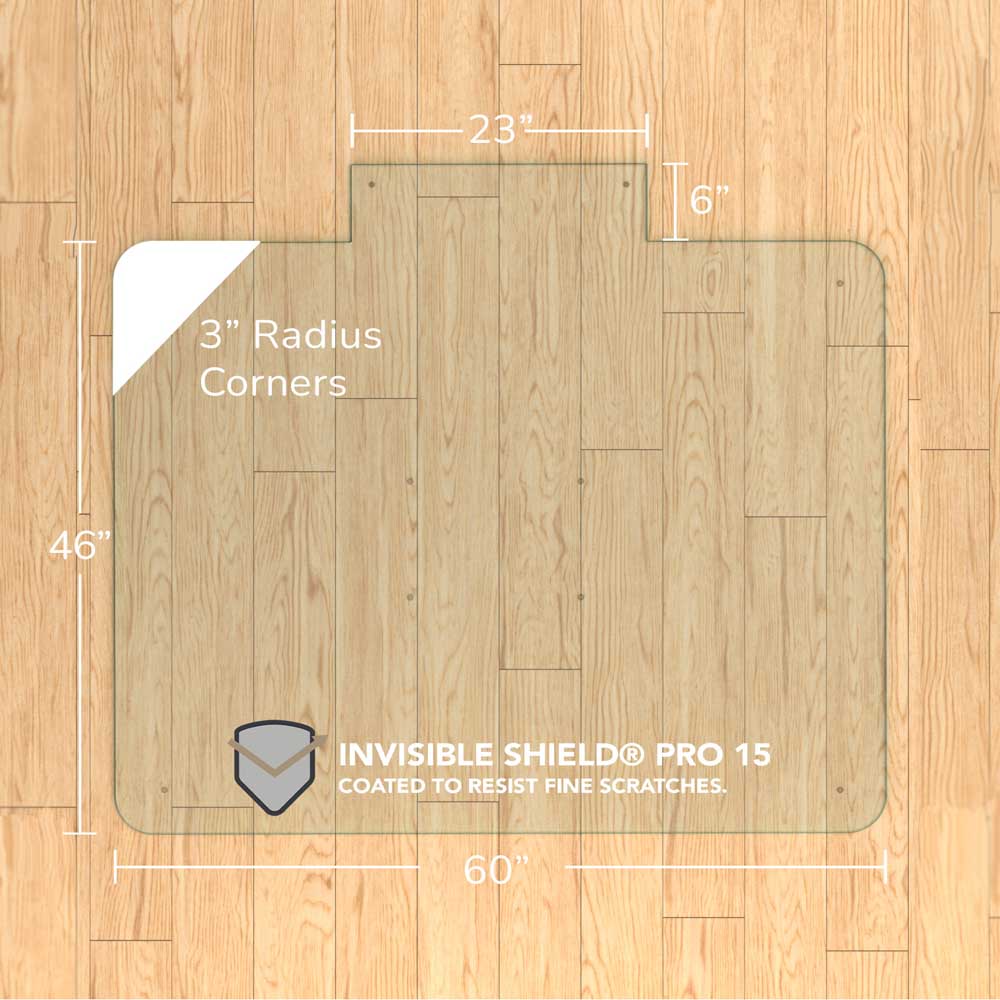#glass clarity_chiaro (standard clear) alt="A rectangular "chiaro" glass chair mat with dimensions 60 inches by 46 inches, featuring a 23-inch wide top section and 6-inch extension, and 3-inch radius corners. The mat is labeled with "INVISIBLE SHIELD® PRO 15 COATED TO RESIST FINE SCRATCHES." and is placed on a wooden floor."

