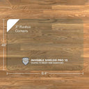 A rectangular chiaro glass chair mat with dimensions of 84 inches by 48 inches, featuring 3-inch radius corners. The mat is labeled with "INVISIBLE SHIELD® PRO 15 COATED TO RESIST FINE SCRATCHES." and is placed on a wooden floor. #Size_48x84#Glass_Clarity_Chiaro
