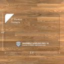 A rectangular luminoso glass chair mat with dimensions of 84 inches by 48 inches, featuring 3-inch radius corners. The mat is labeled with "INVISIBLE SHIELD® PRO 15 COATED TO RESIST FINE SCRATCHES." and is placed on a wooden floor. #Size_48x84#Glass_Clarity_Luminoso
