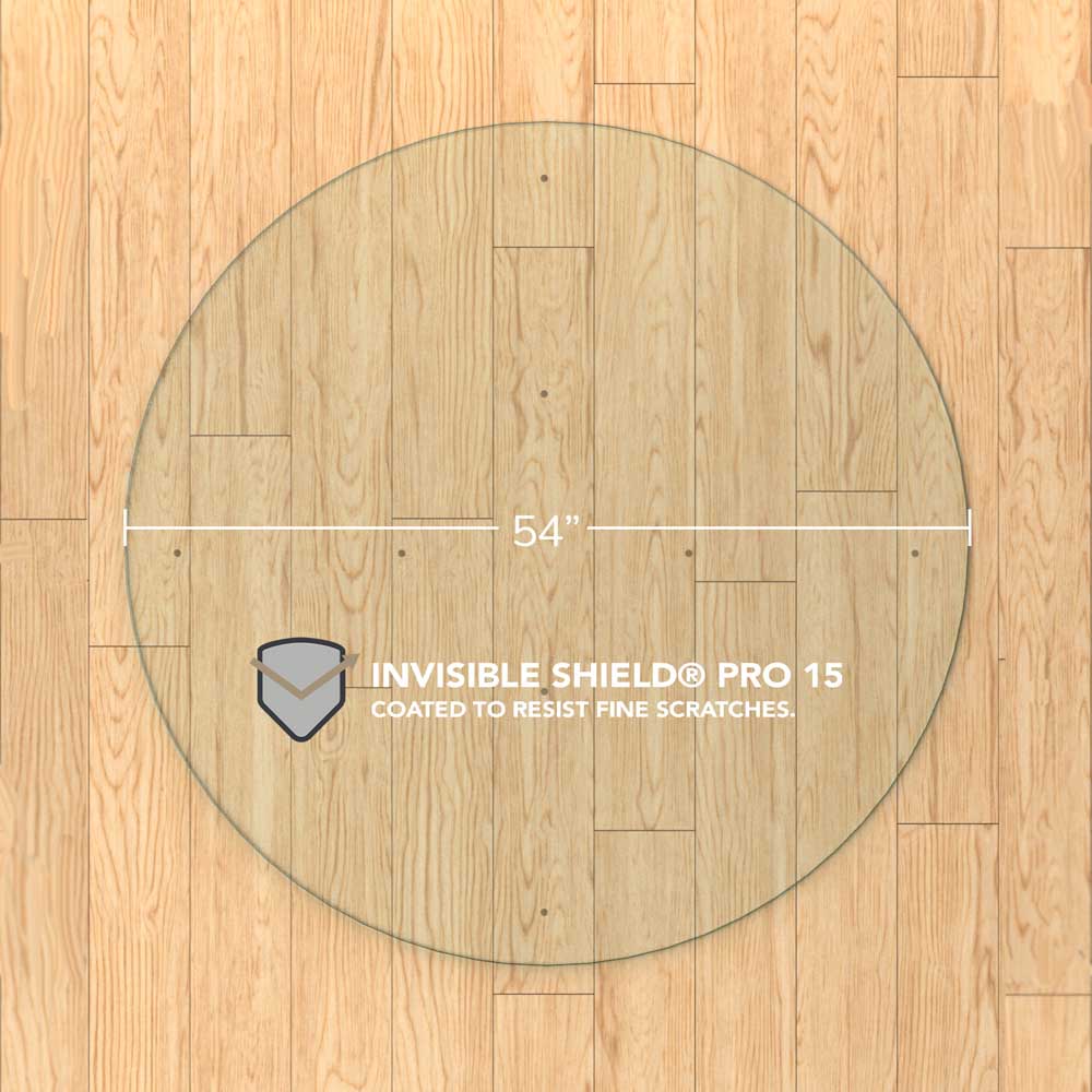 #glass clarity_chiaro (standard clear) alt="A round "chiaro" glass chair mat with a diameter of 54 inches, placed on a wooden floor. The mat is labeled with "INVISIBLE SHIELD® PRO 15 COATED TO RESIST FINE SCRATCHES."
