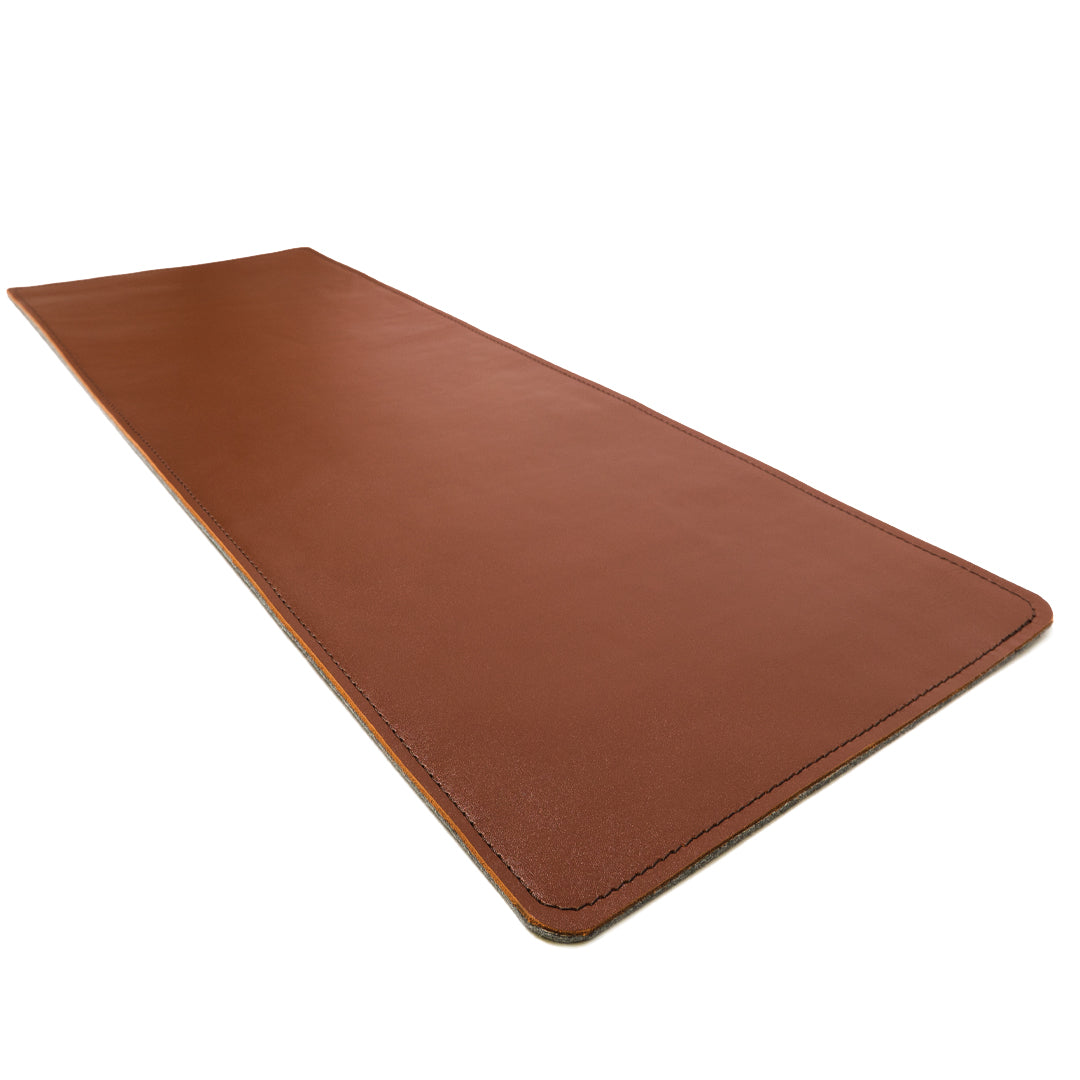 #color_mahogany A sleek, brown leather desk mat photographed against a white background. The mat is rectangular with neatly stitched edges.
