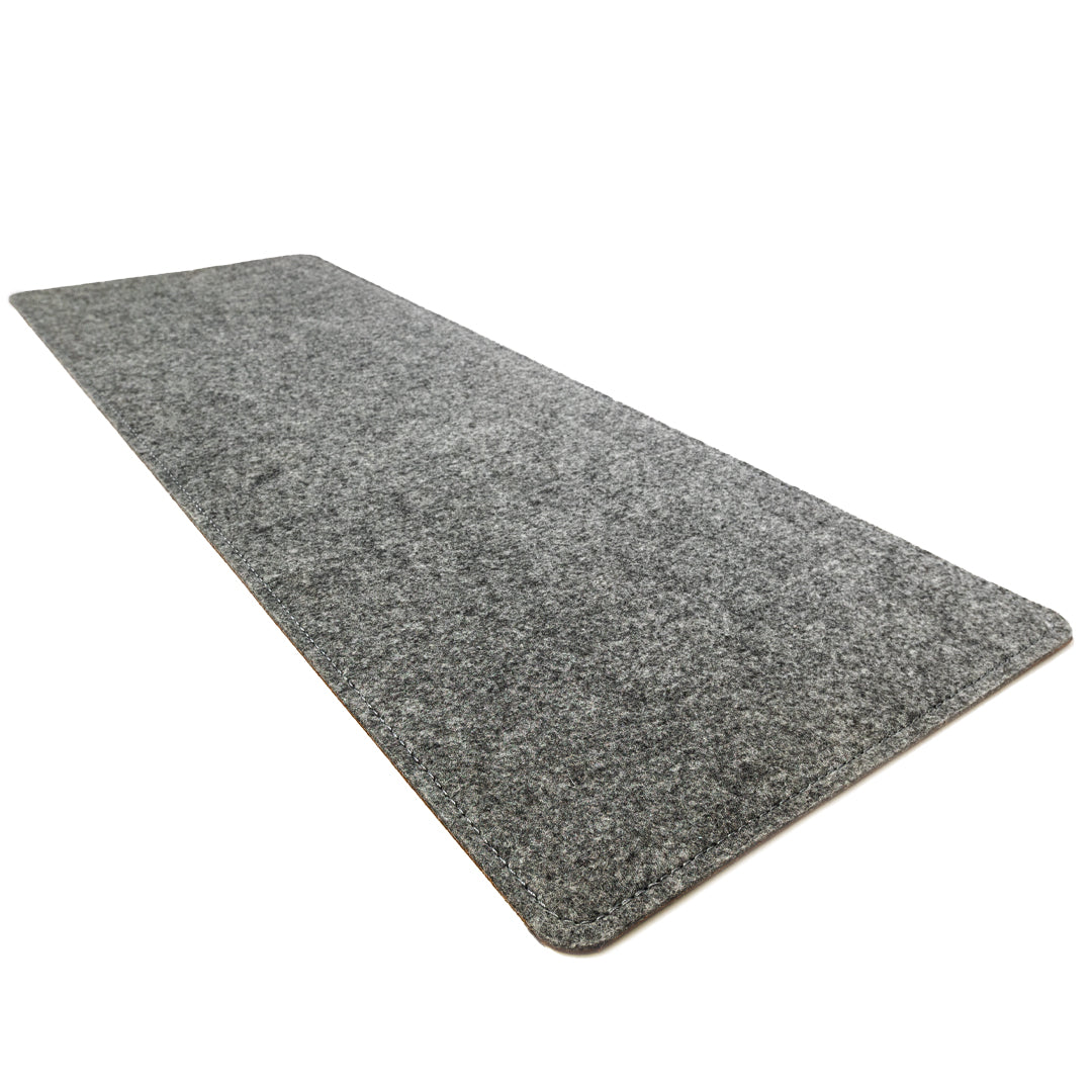#color_mahogany A sleek, gray felt desk mat photographed against a white background. The mat is rectangular with neatly stitched edges.