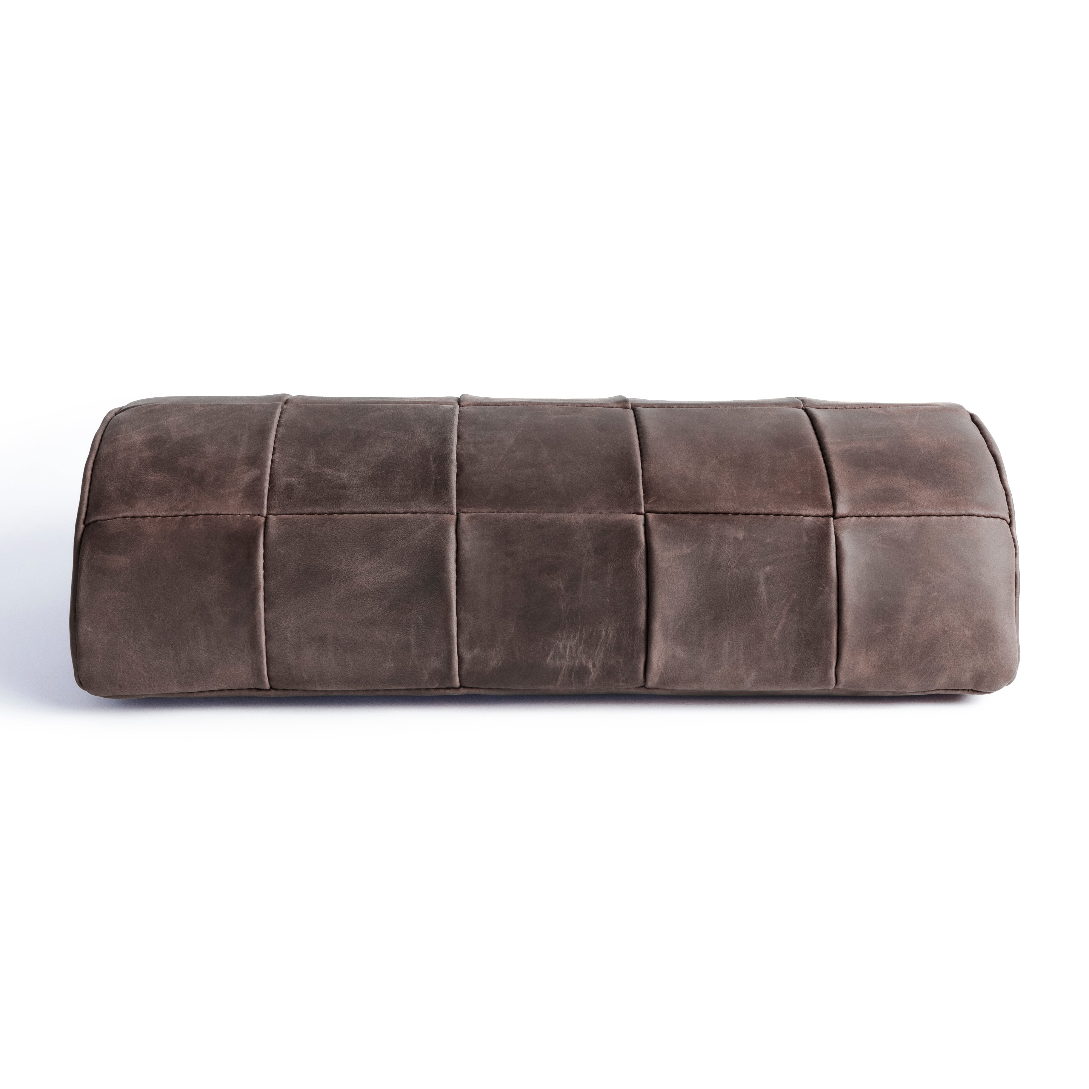 #color_espresso alt="A dark brown, quilted leather foot rest photographed against a white background. The foot rest has a rectangular shape with a stitched pattern creating a quilted effect."