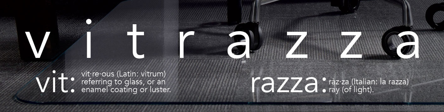 A graphic with the word "VITRAZZA" in large, bold letters. Below it, the text explains the etymology: vit: From "vitreous" (Latin: vitrum), referring to glass, or an enamel coating or luster. raZZa: From Italian "la razza," meaning "ray (of light)." The background shows a textured surface with parts of office chairs visible.